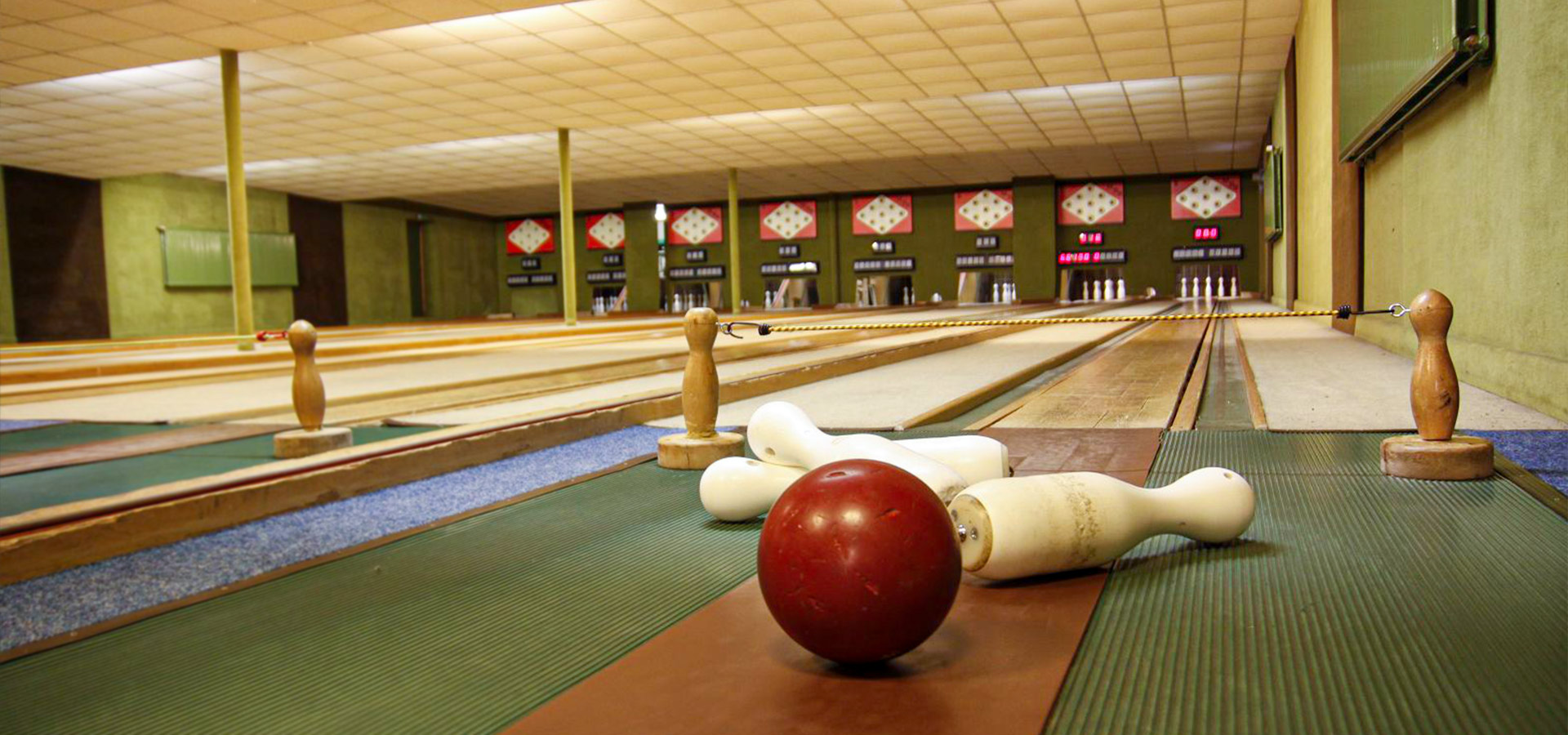 Nahaufnahme einer Bowlingkugel und Kegeln in einer Bowlinghalle.